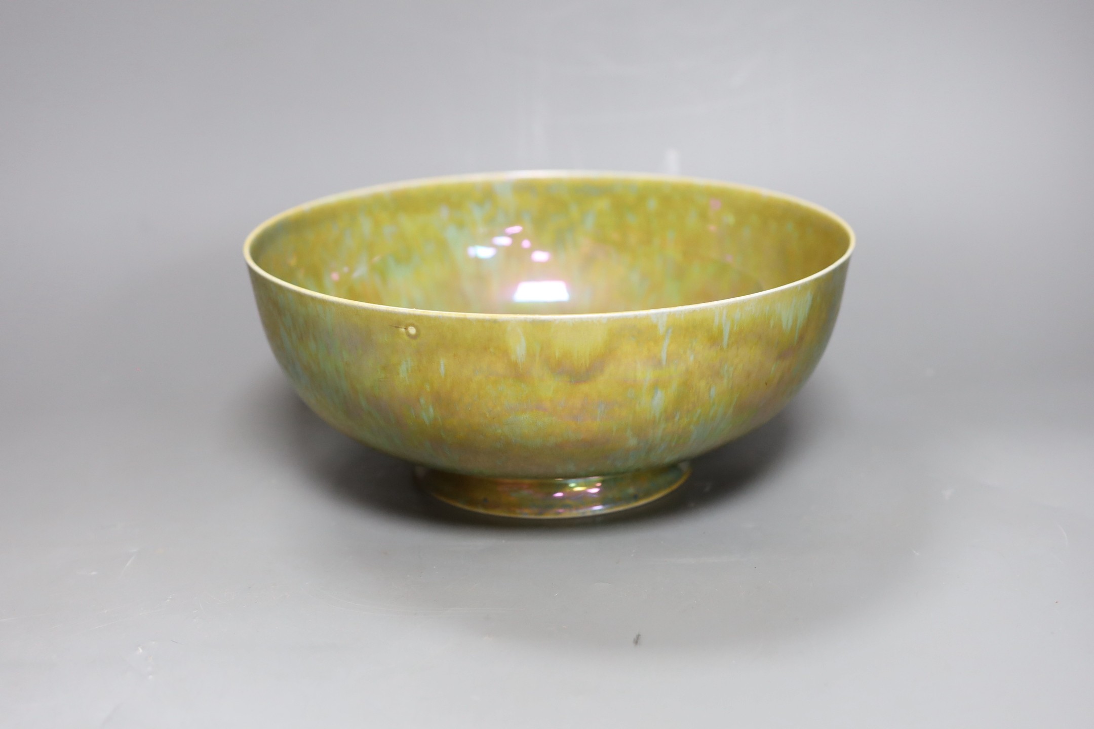 A Ruskin thinly potted green and ochre lustre fruit bowl, dated 1923, 25cm diameter
